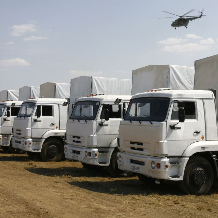Trucks from a Russian humanitarian convoy are parked on a field outside the town of Kamensk-Shakhtinsky in the Rostov region, some 30kms from the Russian-Ukrainian border, Russia, on August 14, 2014. A massive Russian