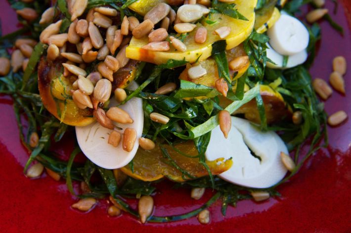 Shaved collard greens salad with turmeric vinaigrette, roasted squash, and toasted sunflower seeds.