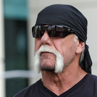 Reality TV star and former pro wrestler Hulk Hogan, whose real name is Terry Bollea, looks on as his attorney speaks during a news conference Monday, Oct. 15, 2012 at the United States Courthouse in Tampa, Fla. Hogan says he was secretly taped six years ago having sex with the ex-wife of DJ Bubba 