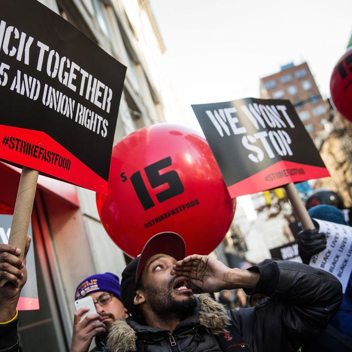 Protesters march through the streets demanding a raise on the minimum wage to $15 per hour on December 4, 2014 in New York, United States. The movement, driven largely by fast food workers, has risen in prominence in the past year; today's protests were also joined by demonstrators angry at the Grand jury verdict to not indict the police officer who killed Eric Garner in July, 2014. 