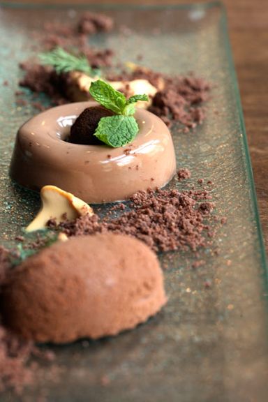 milk chocolate truffle with coffee powder, caramel, white chocolate mousse, and crumbles of bitter chocolate