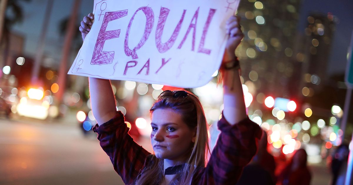 Diverse group of women at a panel discussion emphasizing equal pay