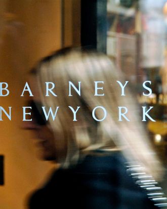 A Barneys New York logo is pictured as a woman enters their 5th Avenue store in New York, Tuesday, March 21, 2006. 