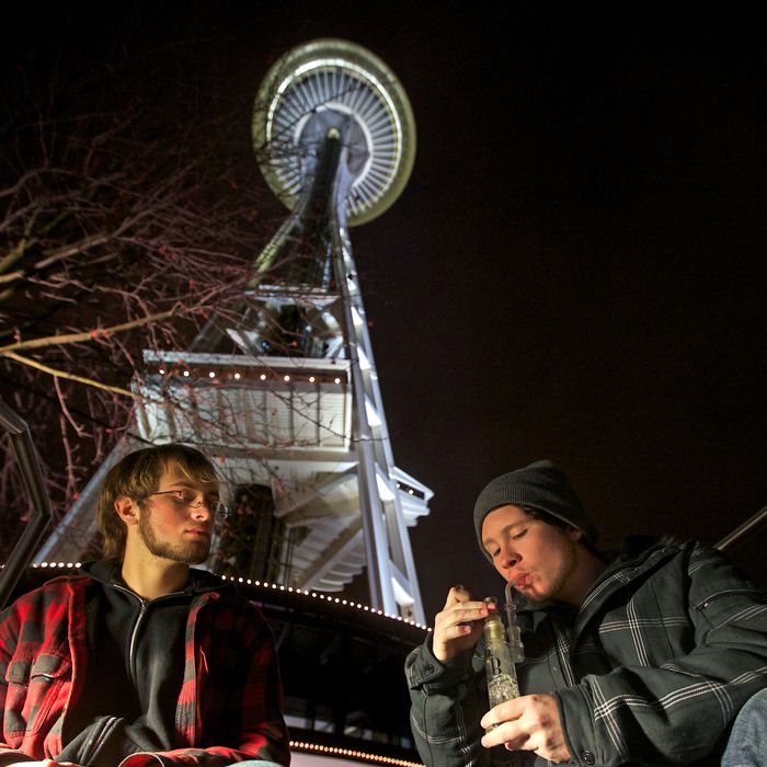 Dustin, left, and Paul of Tacoma, Washington, both of which declined to give their last names, share a water pip underneath the Space Needle shortly after a law legalizing the recreational use of marijuana took effect on December 6, 2012 in Seattle, Washington. Voters approved an initiative to decriminalize the recreational use of marijuana making it one of the first states to do so.