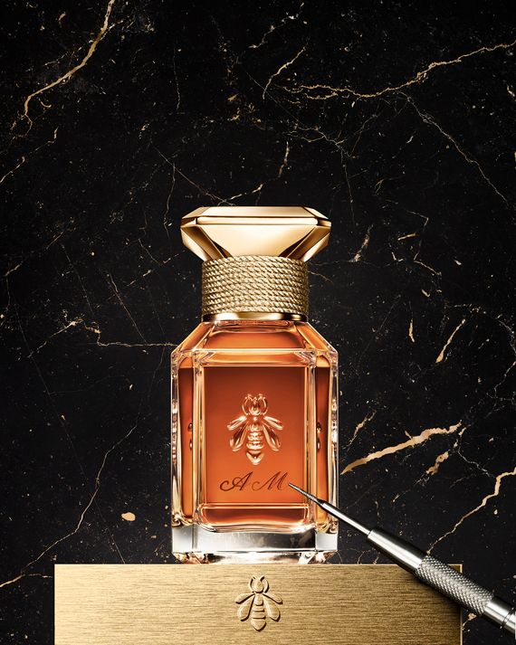 A bottle of Guerlain perfume with an example of personalized engraving including the initials