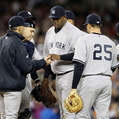 New York Yankee manager Joe Girardi #28 makes a pitching change removing C.C. Sabathia #52 in the sixth inning.