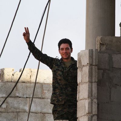 A man flashes victory sign in Kobani, Syria on January 27, 2015 after it has been freed from Islamic State of Iraq and the Levant (ISIL).