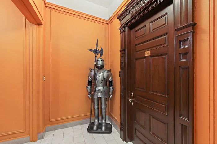 A knight's suit of armor standing outside a doorway