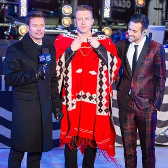 NEW YORK, NY - DECEMBER 31: (L-R) Ryan Seacrest, Macklemore and Ryan Lewis attend Dick Clark's New Year's Rockin' Eve with Ryan Seacrest 2014 in Times Square on December 31, 2013 in New York City. (Photo by Michael Stewart/WireImage)