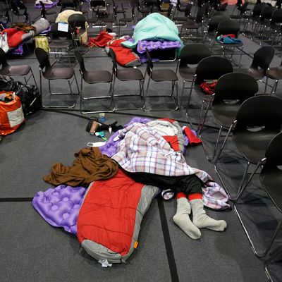 Someone sleeps on the ground in a warming shelter in Austin, Texas.