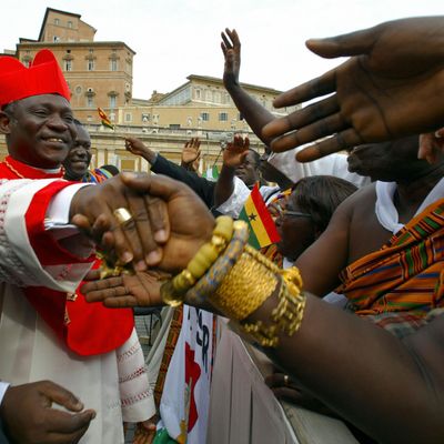 Newly appointed cardinal Peter Kodwo Appiah Turkson of Ghana salutes his compatriots after the ordination ceremony celebrated by Pope John Paul II on St Peter square 21 October 2003 at the Vatican. The 30 cardinals appointed today will bring the Consistory to 135 cardinal-electors who will meet in conclave to elect a next Pope after his death. 