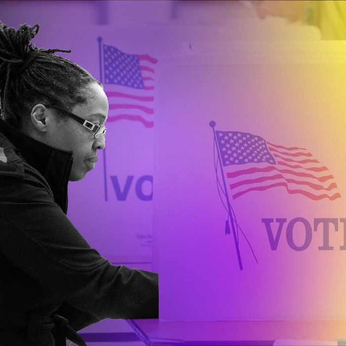 A Black woman stands at a voting booth.