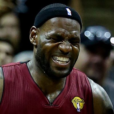 LeBron James #6 of the Miami Heat reacts after cramping up against the San Antonio Spurs during Game One of the 2014 NBA Finals at the AT&T Center on June 5, 2014 in San Antonio, Texas.