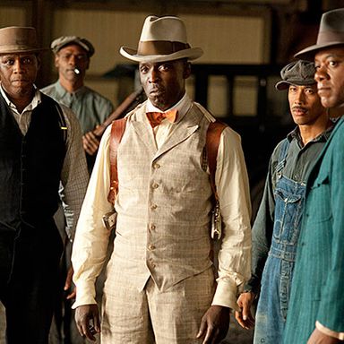 Chalky White is a dapper guy, and he really makes his long red overcoat work. But this subtler plaid ensemble matches his leather holsters.