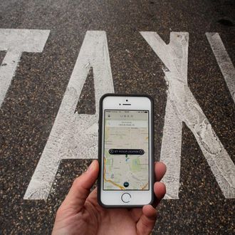 MADRID, SPAIN - OCTOBER 14: In this photo illustration the new smart phone taxi app 'Uber' shows how to select a pick up location next to a taxi lane on October 14, 2014 in Madrid, Spain. 'Uber' application started to operate in Madrid last September despite Taxi drivers claim it is an illegal activity and its drivers currently operate without a license. 'Uber' is an American based company which is quickly expanding to some of the main cities from around the world. (Photo by Pablo Blazquez Dominguez/Getty Images)