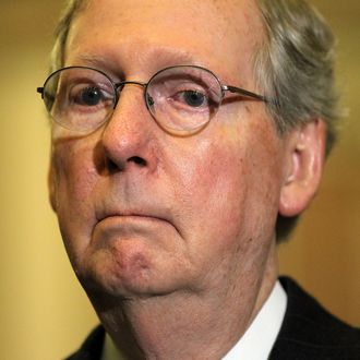 U.S. Senate Minority Leader Sen. Mitch McConnell (R-KY) listens during a news briefing after the weekly Senate Republican Policy Luncheon December 11, 2012 on Capitol Hill in Washington, DC. McConnell discussed various topics with the media including the fiscal cliff issue saying 