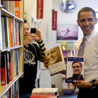 US President Barack Obama holds up copie