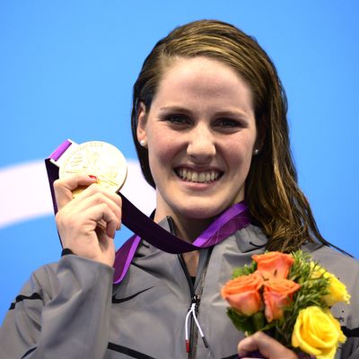 US swimmer Missy Franklin poses on the podium with the gold medal after winning the women's 100m backstroke swimming event at the London 2012 Olympic Games in the Aquatics Centre at the Olympic Park in London on July 30, 2012.