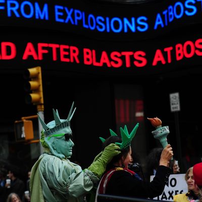 A news banner in New York announces casualties after blasts occured at the finish line of the Boston Marathon, April 15, 2013. At least two people were killed and 37 others wounded when two explosions struck near the finish line of the Boston Marathon,, sparking scenes of panic.