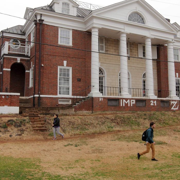 Students walk past the Phi Kappa Psi fraternity house on the University of Virginia campus on December 6, 2014 in Charlottesville, Virginia.