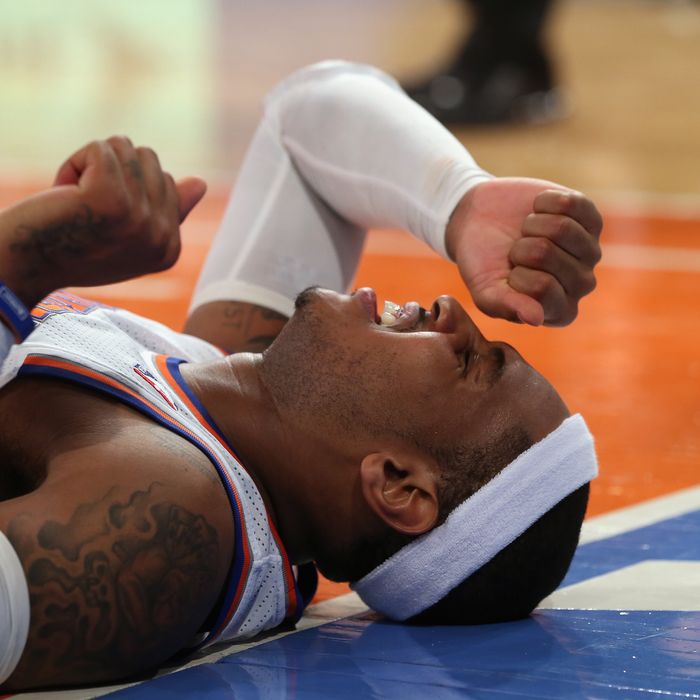 Carmelo Anthony #7 of the New York Knicks lies on the court after being fouled in the game against the Los Angeles Lakers at Madison Square Garden on December 13, 2012 in New York City. Anthony left the game with a sprained ankle. 