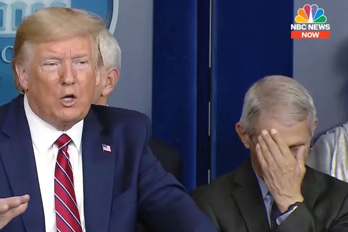 Dr. Anthony Fauci rubs his face as President Donald Trump speaks during a COVID-19 briefing at the White House. 