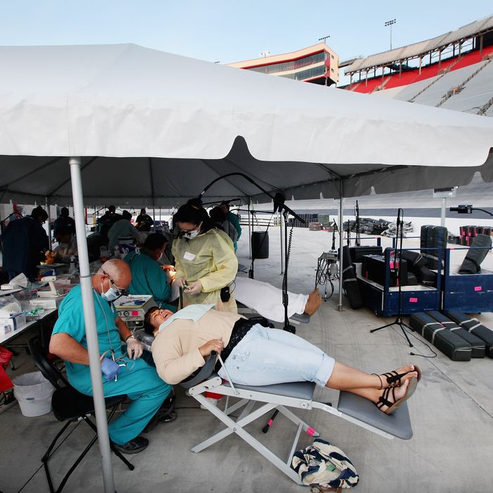 Uninsured patient Patricia Breto receives dental care from volunteers Dr. David Reczek of Boston and dental student Yasmin Gonzalez from Champaign, Illinois at the Remote Area Medical (RAM) free clinic at the Bristol Motor Speedway, located in the mountains of Appalachia, on April 15, 2012 in Bristol, Tennessee. More than one thousand uninsured and underinsured people received free medical, dental, vision and pulmonary treatments provided by volunteer doctors, dentists, optometrists, nurses and support staff during the three day clinic in the foothills of the Appalachian Mountains, one of the poorest regions in the country. The U.S. Supreme Court recently heard arguments over the constitutionality of President Obama's sweeping health care overhaul. 