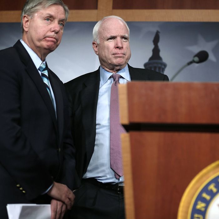 WASHINGTON, DC - FEBRUARY 14: U.S. Senator John McCain (R-AZ) (R), and Senator Lindsey Graham (R-SC) (L) speak to the press during a news conference on the terror attack that killed four Americans in Benghazi February 14, 2013 on Capitol Hill in Washington, DC. The senators questioned why the Obama Administration did not seek enough help from the Libya government during the attack. (Photo by Alex Wong/Getty Images)