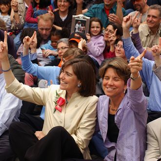 Julie (L) and Hillary Goodridge attend a group photo on May 17, 2005 to celebrate the first anniversary of the passing of the same sex marriage law in front of the State House in Boston, Massachusetts. The Goodridges were the first couple to be married under the law in the state of Massachusetts.
