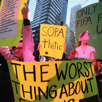 Protesters demonstrate against the proposed Stop Online Piracy Act (SOPA) and Protect IP Act (PIPA) outside the offices of U.S. Sen. Charles Schumer (D-NY) and U.S. Sen. Kirsten Gillibrand (D-NY) on January 18, 2012 in New York City. The controversial legislation is aimed at preventing piracy of media but those opposed believe it will support censorship.