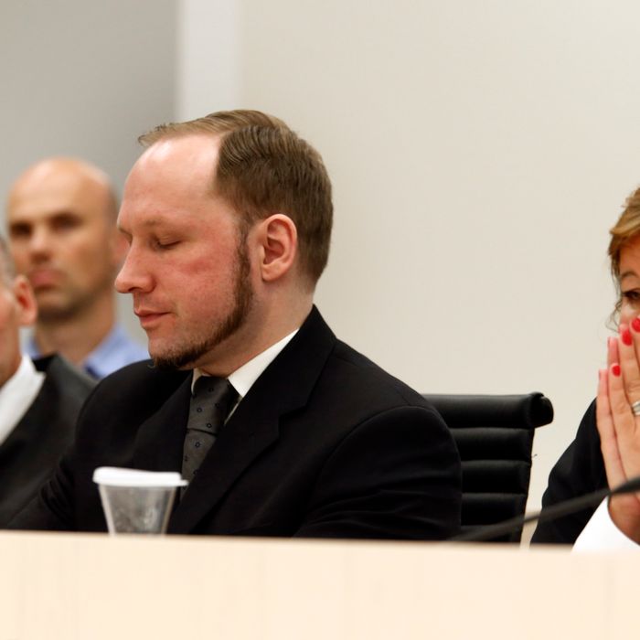 Defender Geir Lippestad (left) and defender Vibeke Hein Baera sit together with terror accused Anders Behring Breivik when Oslo Court passes judgment against him in Oslo Courthouseon August 24, 2012. The court on Friday found Anders Behring Breivik guilty of 