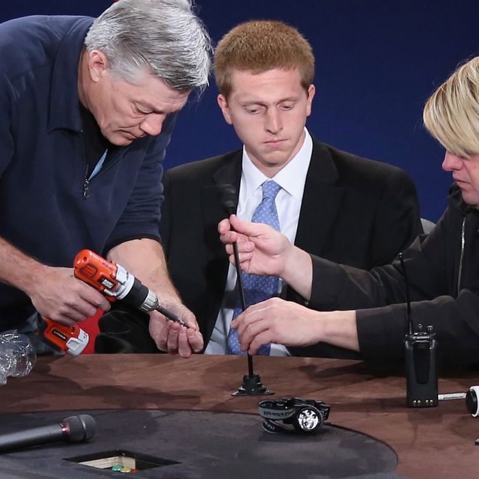 DANVILLE, KY - OCTOBER 10: Technicians screw a microphone in place as a student (C) from Centre College stands in for Vice President Joe Biden during lighting tests on stage at the college October 10, 2012 in Danville, Kentucky. Biden and Republican vice presidential nominee Rep. Paul Ryan (R-WI) will participate in the one and only vice presidential debate of the election tomorrow. (Photo by Chip Somodevilla/Getty Images)