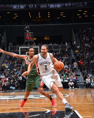 Deron Williams #8 of the Brooklyn Nets drives to the basket against Larry Sanders #8 of the Milwaukee Bucks during the game at the Barclays Center on December 9, 2012 in Brooklyn, New York. 