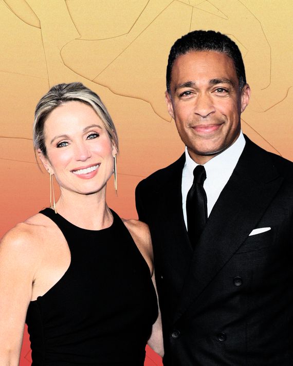 A blonde white woman wearing a black halter dress and a black man wearing a dark suit and tie smile for the camera. The woman has her left arm around the man's back. 