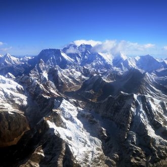 This photograph taken from an aircraft shows an aerial view of Mount Everest (C) and The Himalayan mountain range, some 140kms (87 miles) north-east of Kathmandu on April 3, 2013, on the 80th anniversary of the first manned flight over Mount Everest, the world's tallest mountain. This year is the 60th anniversary of the first summit of the 8848-metre peak. AFP PHOTO/Prakash MATHEMA (Photo credit should read PRAKASH MATHEMA/AFP/Getty Images)