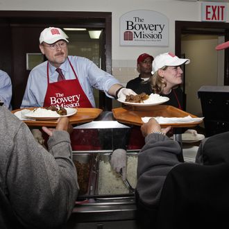 Mayoral candidate JOE LHOTA and his wife TAMRA serve food to those in need at The Bowery Mission in Manhattan, New York.