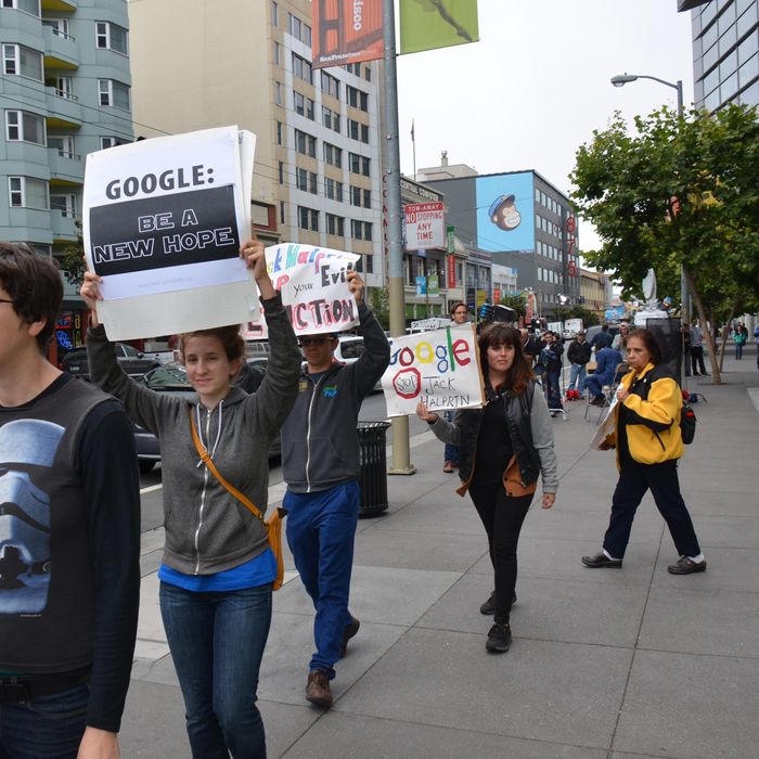 San Francisco, United States. 25th June 2014 -- A woman pickets with a 'Google: be a new hope' sign during a 'Star Wars' themed protest outside Moscone West during the Google I/O conference opening keynote. -- A Star Wars themed 'Don't be evil' protest was held outside Moscone West as the Google I/O conference opened. People protested on issues of eviction and Google buses, wages for security guards working at Google and taxation.