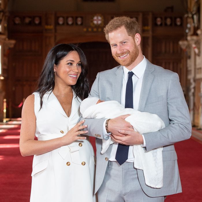 Meghan Markle and Prince Harry holding baby Archie.