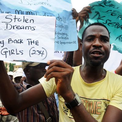 A man carries placard to campaign for the release of schoolgirls kidnapped by Boko Haram Islamists more than two weeks ago during worker's rally in Lagos on May 1, 2014. The mass kidnapping in the Chibok area of northeastern Borno state was one of the most shocking attacks in Boko Haram's five-year extremist uprising, which has killed thousands across the north and centre of the country. AFP PHOTO/PIUS UTOMI EKPEI (Photo credit should read PIUS UTOMI EKPEI/AFP/Getty Images)