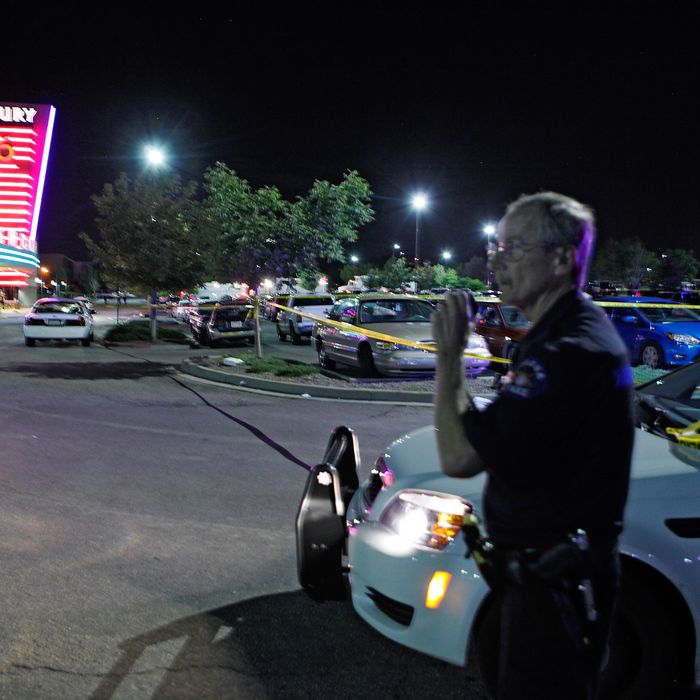 An Aurora Police officer talks on his radio outside of the Century 16 theater at Aurora Mall where as many as 14 people were killed and many injured at a shooting at the Century 16 movie theatre in Aurora, Colo., Friday, July 20, 2012. (AP Photo/Ed Andrieski)