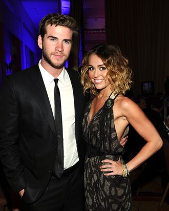 Actress/singer Miley Cyrus and Liam Hemsworth backstage during Muhammad Ali's Celebrity Fight Night XVIII held at JW Marriott Desert Ridge Resort & Spa on March 24, 2012 in Phoenix, Arizona.