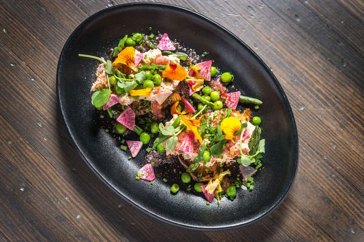 Peekytoe-crab salad with nasturtium vinaigrette and spring vegetables.