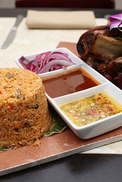 Slow-roasted pork with onion escaveche served with pigeon pea rice
