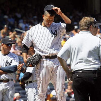 Andy Pettitte #46 of the New York Yankees stands on the mound he is checked on after he was hit with a batted ball in the fifth inning against the Cleveland Indians at Yankee Stadium on June 27, 2012 in the Bronx borough of New York City. 