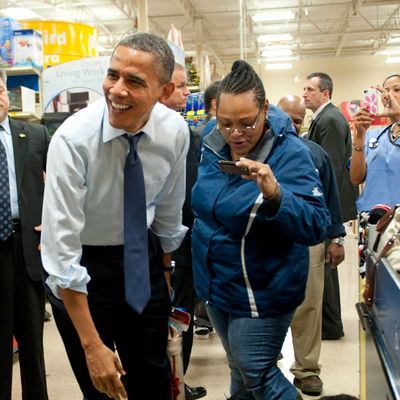 ALEXANDRIA, VA - DECEMBER 21: (AFP OUT) U.S. President Barack Obama laughs as his dog Bo sniffs another dog as he shops at Petsmart on December 21, 2011 in Alexandria, Virginia. President Obama called on House Speaker Rep. John A. Boehner (R-OH) on to urge him again to allow a vote on a Senate-passed measure that would extend a payroll tax holiday for two months. (Photo by Kevin Dietsch-Pool/Getty Images)