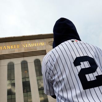A fan wearing a Derek Jeter jersey stands outside of Yankee Stadium prior to his last game there on September 25, 2014 the Bronx borough of New York City. (Photo by Mike Stobe/Getty Images)