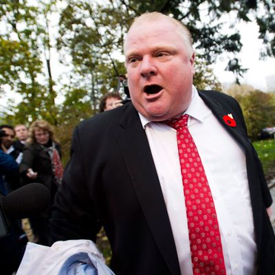 Toronto Mayor Rob Ford tells to the media to get off his property as he leaves his home in Toronto on Thursday, Oct. 31, 2013. A judge on Wednesday ordered the release of police documents in the drug case against a friend of Ford. Peter Jacobsen, a lawyer for various Canadian news organizations that pushed to release the records, said the case against Alexander Lisi involves the mayor. (AP Photo/, Nathan Denette)