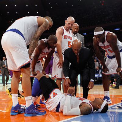  Carmelo Anthony #7 of the New York Knicks lies on the court after being fouled in the game against the Los Angeles Lakers at Madison Square Garden on December 13, 2012 in New York City. Anthony left the game with a sprained ankle. NOTE TO USER: User expressly acknowledges and agrees that, by downloading and/or using this photograph, user is consenting to the terms and conditions of the Getty Images License Agreement. The Knicks defeated the Lakers 116-107. 