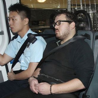 03 Nov 2014, Hong Kong, China --- epa04474129 29-year-old British banker Rurik Jutting (C) is guarded by police on his way to the Eastern Magistrates' Courts in Hong Kong, China, 03 November 2014. Jutting faces murder charges after he was arrested on 01 November 2014 after police found the body of an Indonesian woman with her throat slashed at his flat. Police later discovered the body of another Indonesian woman on the balcony of the apartment in the Wan Chai district of Hong Kong Island. EPA/Apple Daily CHINA OUT - TAIWAN OUT - HONG KONG OUT EDITORIAL USE ONLY --- Image by ? Apple Daily/epa/Corbis
