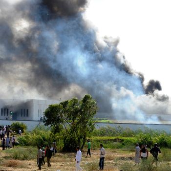 Smoke rises from the burning vehicles at the car park of the US embassy in Tunis during a protest against a film mocking Islam on September 14, 2012. The demonstrators, acting aggressively, managed to clamber over one of the walls round the mission, near the car park where several vehicles had been set ablaze, the photographer said.